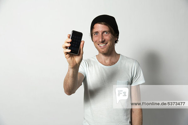 Man holding mobile phone  smiling