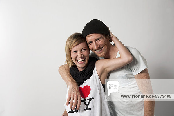 Couple standing against white background  smiling  portrait