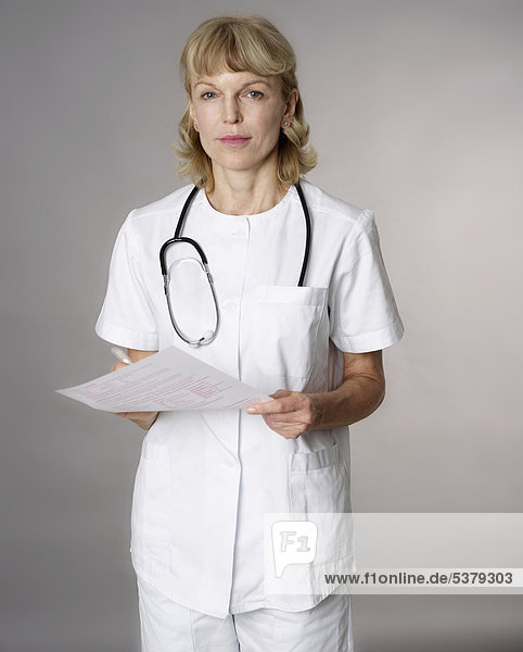 Portrait of mature female doctor with medical record