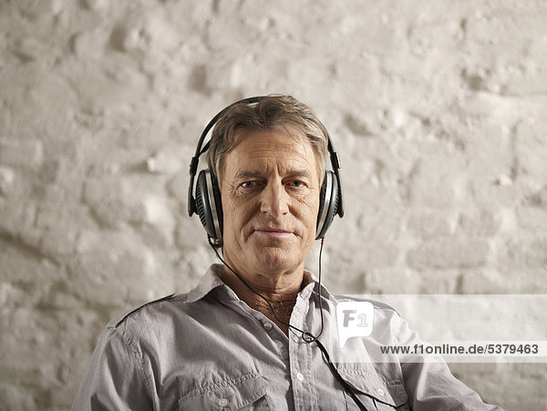 Senior man listening music  portrait