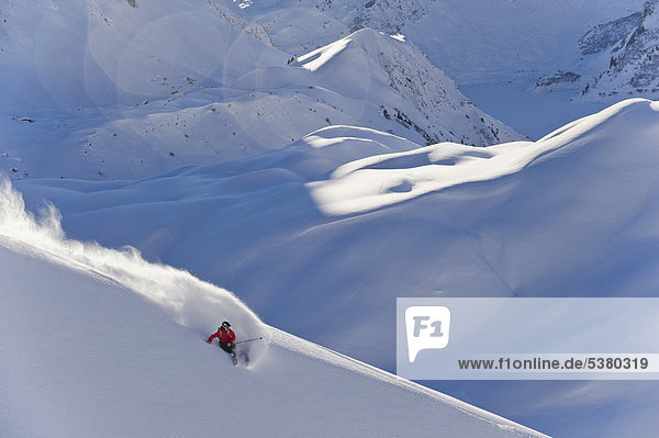 Austria  Zuers  Young man doing telemark skiing on Arlberg mountain