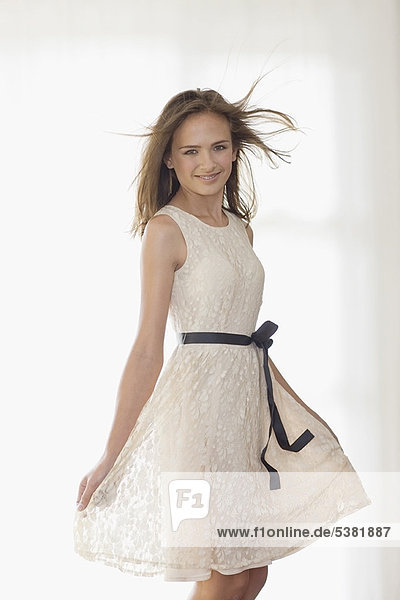 Smiling girl wearing elegant dress