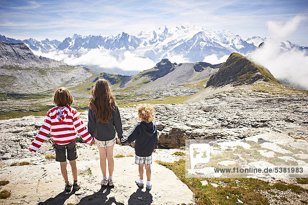 Children standing in rocky landscape