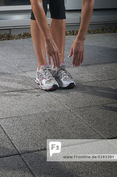 Runner stretching on concrete