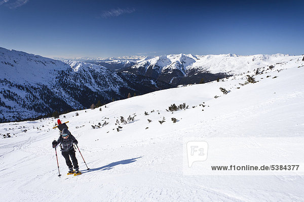 Snowshoe walker climbing to the top of Pfattenspitz mountain  above Durnholz  Sarntal valley at the back  province of Bolzano-Bozen  Italy  Europe