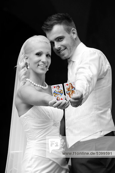 Wedding  bride and groom with playing cards  queen and jack of hearts