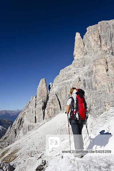 Hiker at Strada degli Alpini via ferrata  looking towards Mt Cima Undici  Strada degli Alpini via ferrata below  Sesto  Sexten  Alta Pusteria Valley  Dolomites  South Tyrol  Italy  Europe
