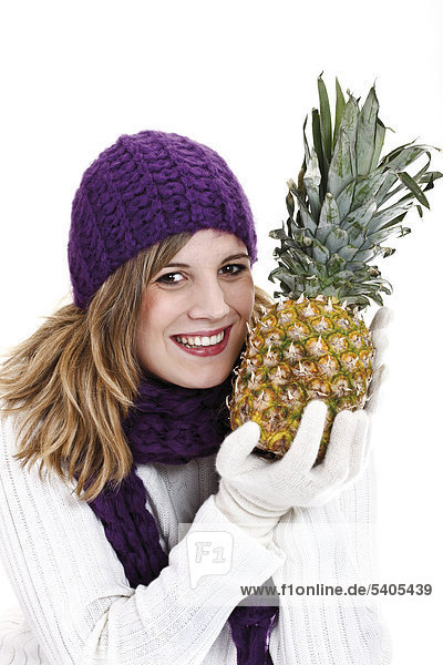 Young woman holding a pineapple