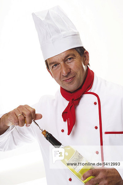 Chef uncorking a bottle of wine