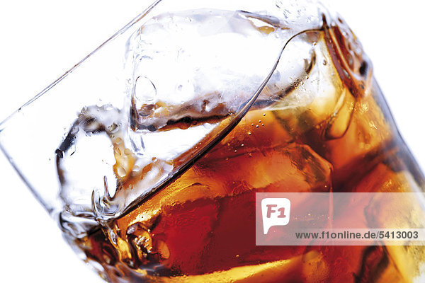 Cola in a glass with ice  closeup