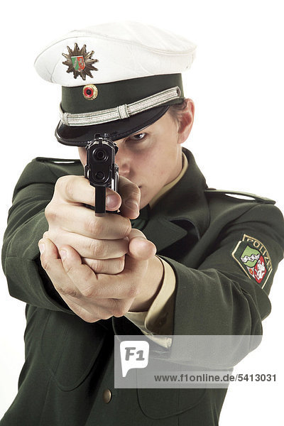 Young policeman with gun at the ready