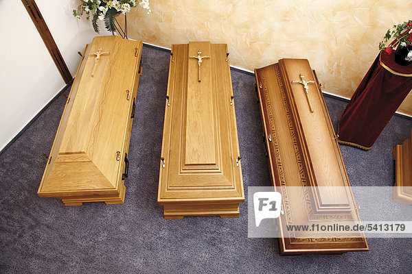 Wooden coffins on display in a showroom  show room