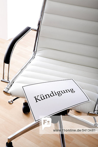 'White office chair  ''Kuendigung''  ''dismissal'' in writing'