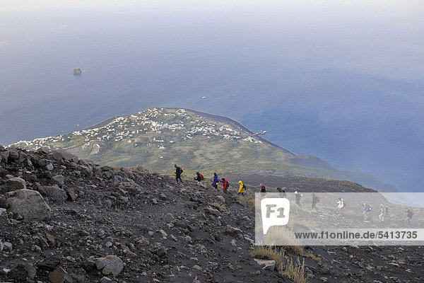 Tourist group hiking to the crater of Mt Stromboli  volcanic island of Stromboli  Aeolian Islands or Lipari Islands  Sicily  Southern Italy  Italy  Europe