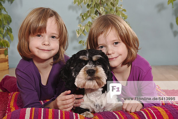 Mädchen  Zwillinge  sechs Jahre  mit Mischlingshund