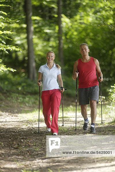 Woman  42  and man  52  doing Nordic Walking