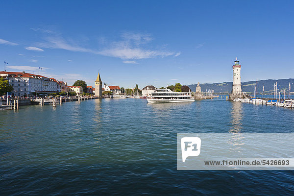 Excursion boat at the port entrance  Mangturm lighthouse  harbour  Lindau  Bodensee  Lake Constance  Bavaria  Germany  Europe