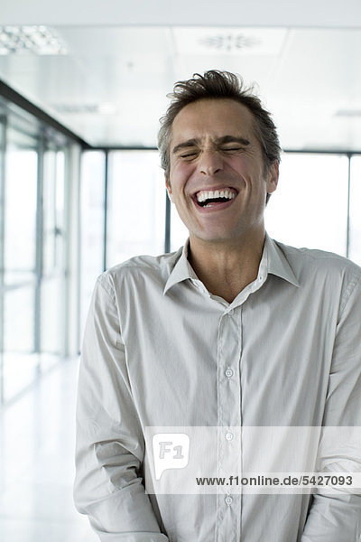 Man with eyes closed  laughing