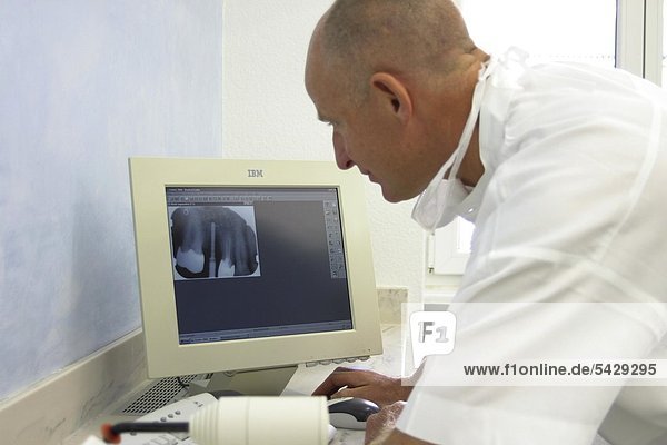 Physican considers radiography on computer monitor