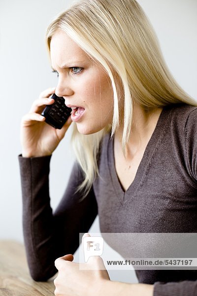 Angry blond woman on the phone
