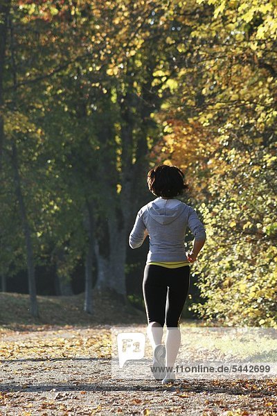 Young Woman running on a sunny autumn afternoon