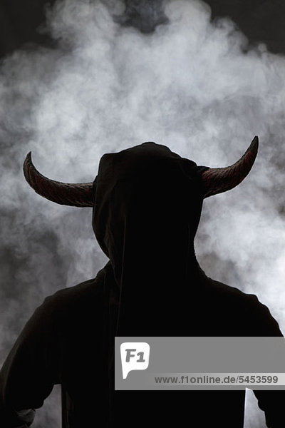 A person with horns attached to head  silhouette