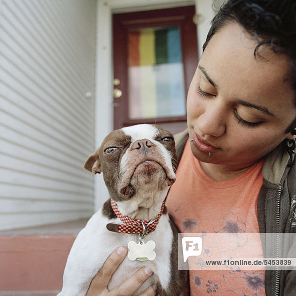 A woman holding her dog mouth