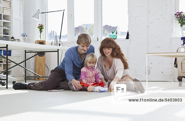 A family playing together on the floor