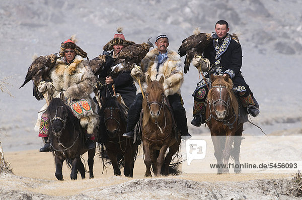 Eagle hunters on route to the Eagle Hunters festival near Ulgii  western Mongolia  Asia