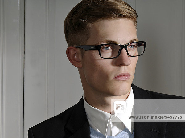 Young man wearing a suit and glasses  portrait
