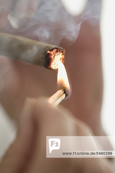 Close up of woman lighting cigarette