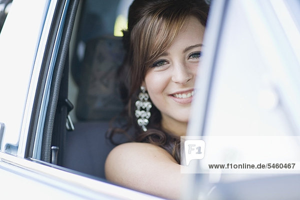 Teenage girl smiling in car