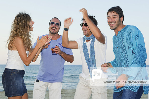 Friends laughing together on beach