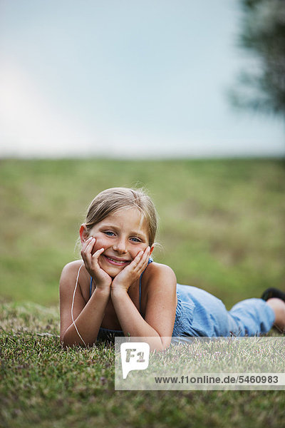 Smiling girl laying in grass