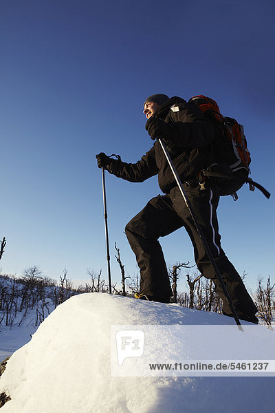 Cross-country skier walking in snow