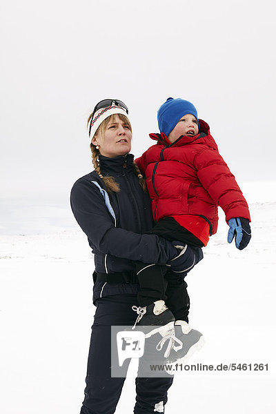Woman holding child in snow