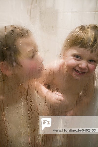 Two boys playing in the shower