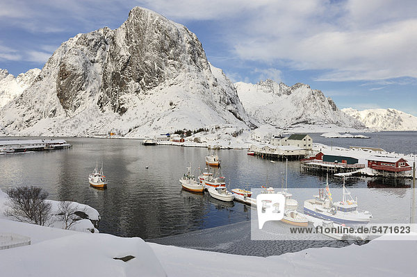 Fishing village with snow-capped mountains