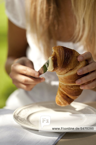 Young woman with croissant