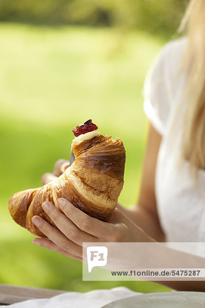 Young woman with croissant