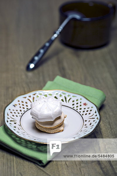 Cookies and meringues stacked on a plate
