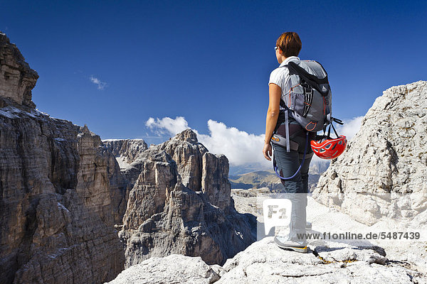 Climber climbing the climbing route on Boeseekofel Mountain  looking towards Pisciadu Mountain  Dolomites  Alto Adige  Italy  Europe