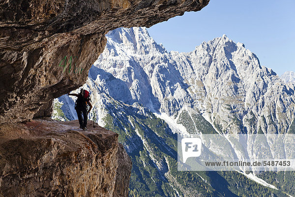 Hiker ascending the Alpinisteig Climbing Route  Sexten  High Puster Valley  Dolomites  Alto Adige  Italy  Europe