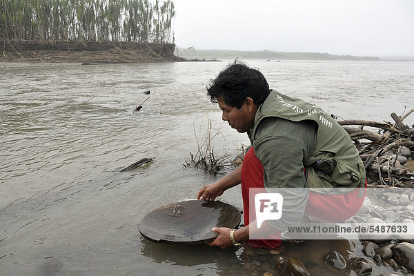 Gold seeker on a river lowlands of Bolivia South America