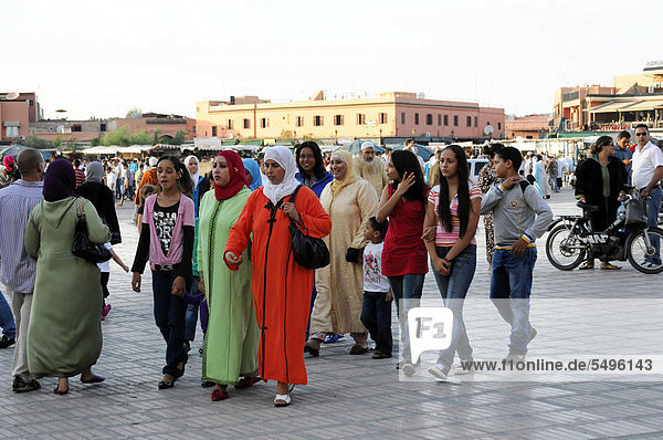'Locals strolling across the Djemaa el Fna square  ''square of the hanged men''  Marrakech  Morocco  Africa'