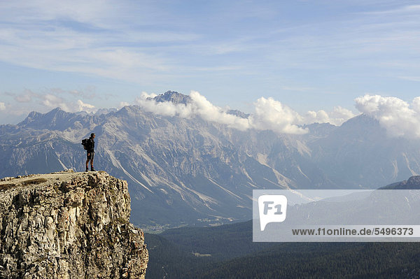 Mountaineer on the summit of Mt Kleiner Lagazuoi with mountain panorama  Dolomites  South Tyrol  Italy  Europe