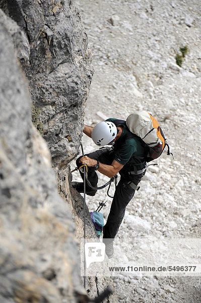 Mountaineer climbing a sheer rock wall  Piz Boe  Dolomites  South Tyrol  Italy  Europe