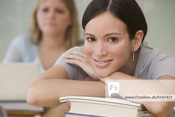 Woman with chin on hand in classroom