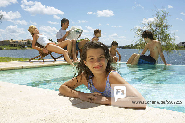 A girl in the pool family in the background.