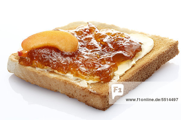 Scheibe Toastbrot mit Aprikosenmarmelade und Aprikosenstück